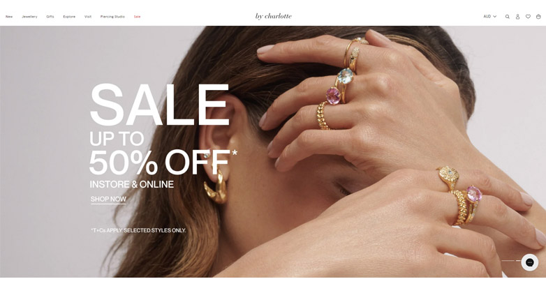 The By Charlotte website homepage features high-quality images of jewelry collections with clean and modern website layout