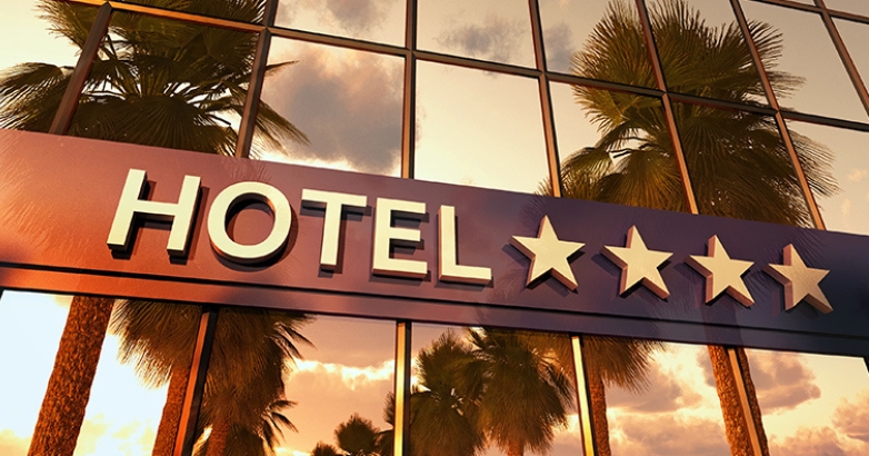 Elegant hotel sign displaying five stars, representing premium service and hospitality branding investment.