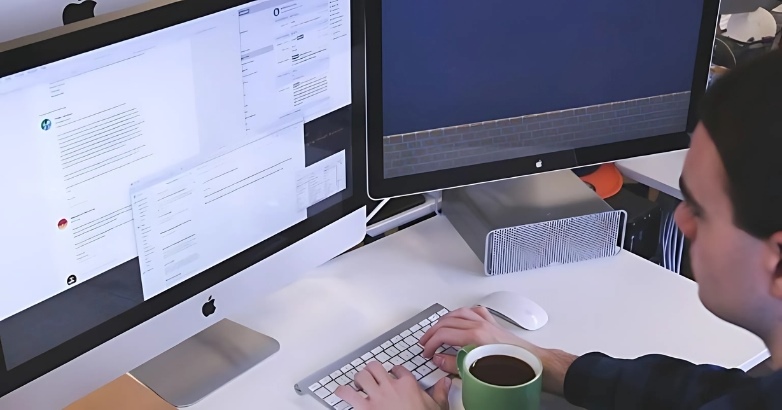 A man at a desk engaged in automated and personalized hotel email marketing efforts.