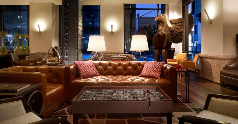 Elegant hotel lobby with leather seating and a statue, representing the evolving landscape of hotel digital marketing.