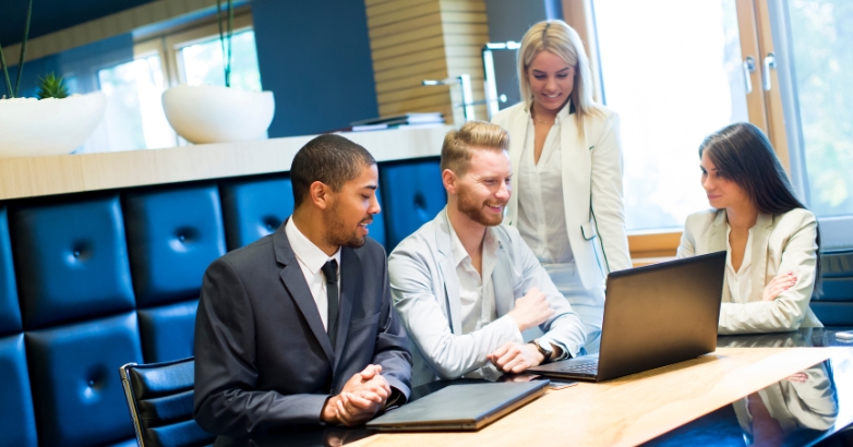 Business team engaged in a meeting about how agencies can enhance hotel digital marketing efforts.