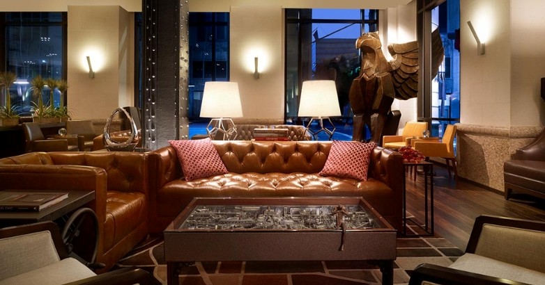 Elegant hotel lobby with leather seating and a statue, representing the evolving landscape of hotel digital marketing.