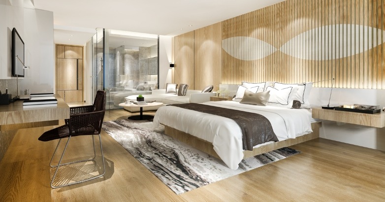 Modern bedroom featuring wooden walls and a neatly made bed, highlighting a cozy and inviting atmosphere.