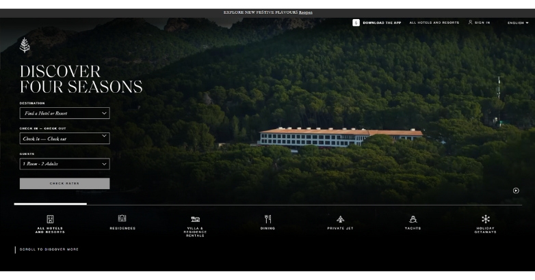 A computer monitor features the Four Seasons hotel website, emphasizing luxury accommodations and services available.