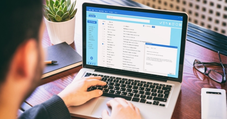 Travel agent using email marketing software to engage clients and promote travel offers.