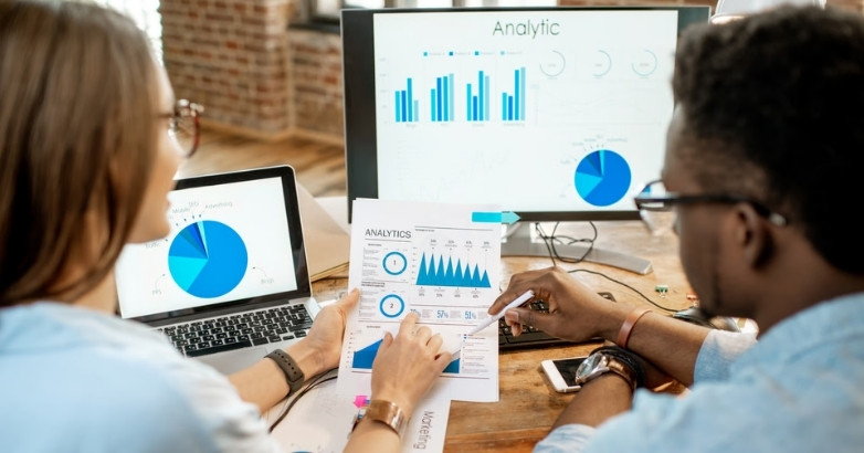 Marketing team reviewing hotel digital marketing performance analytics and campaign data