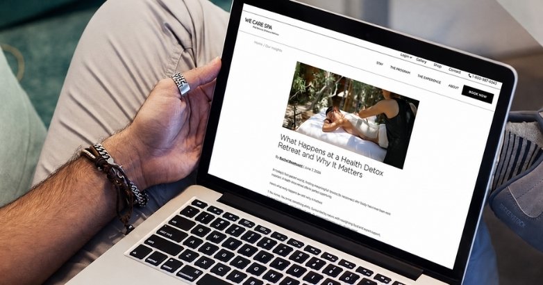 Traveler reading We Care Spa content on a laptop for high-intent hotel SEO