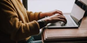 SEO specialist conducting a hotel website audit on a laptop