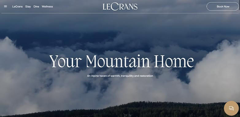 A serene mountain landscape with clouds, featuring the text "Your Mountain Home" and a call to action to book now.