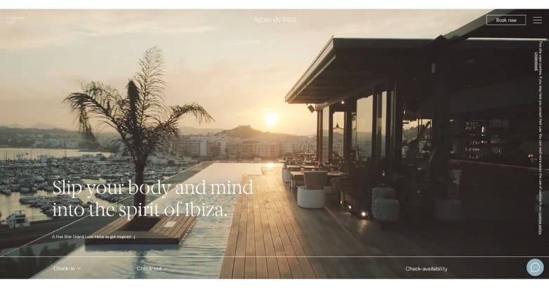 A scenic view of a waterfront restaurant at sunset, featuring palm trees and outdoor seating, promoting relaxation in Ibiza.