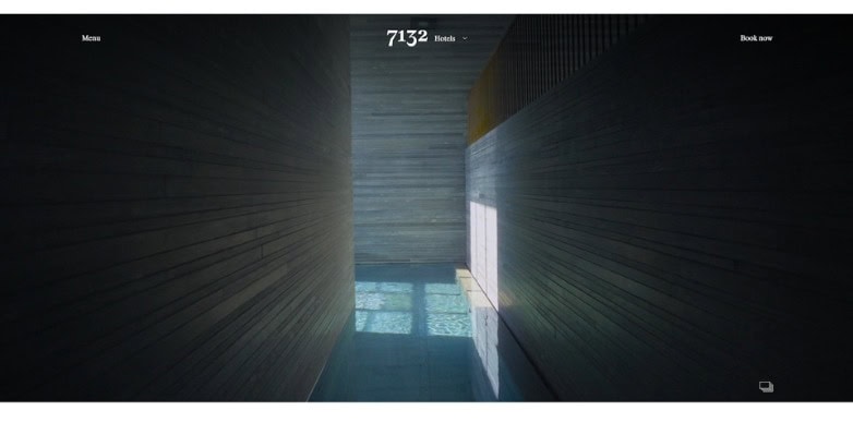 A narrow hallway with wooden walls and a reflective floor, illuminated by natural light from a window at the end.