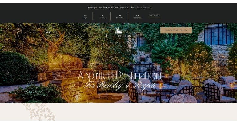 A serene outdoor setting featuring a stone wall, lush greenery, and elegant seating, promoting a destination for relaxation.