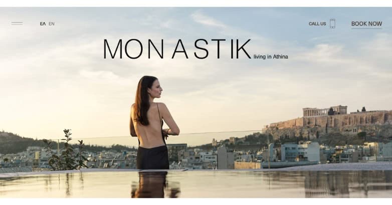 A woman stands by an infinity pool overlooking a cityscape with a historic site in the background, promoting a living space in Athens.