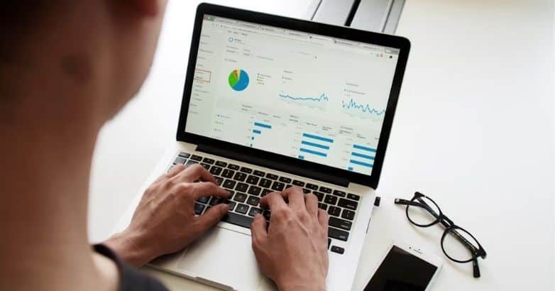 Laptop displaying analytics data for measuring travel content marketing performance and results.