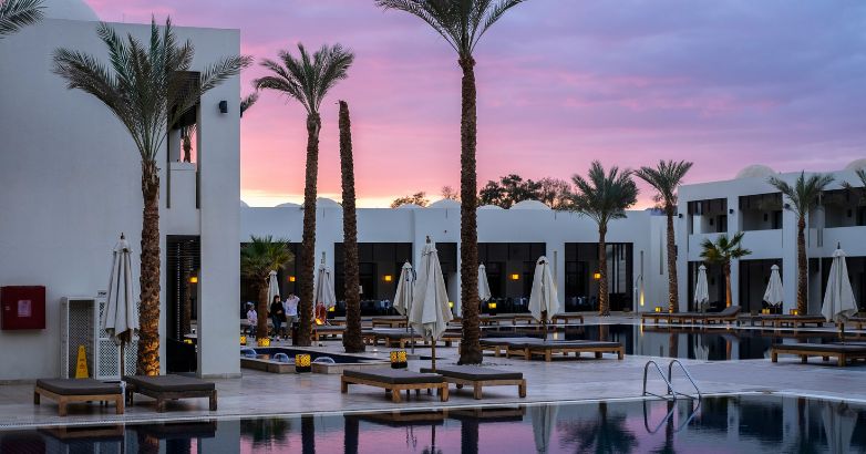 Luxury hotel poolside evening setting with lounges and palm trees, reflecting an understanding of the SEO needs for upscale hospitality businesses