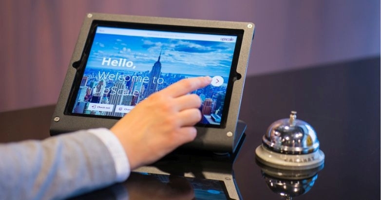 A user displays a hotel on an iPad, emphasizing tourism email marketing and booking system features.