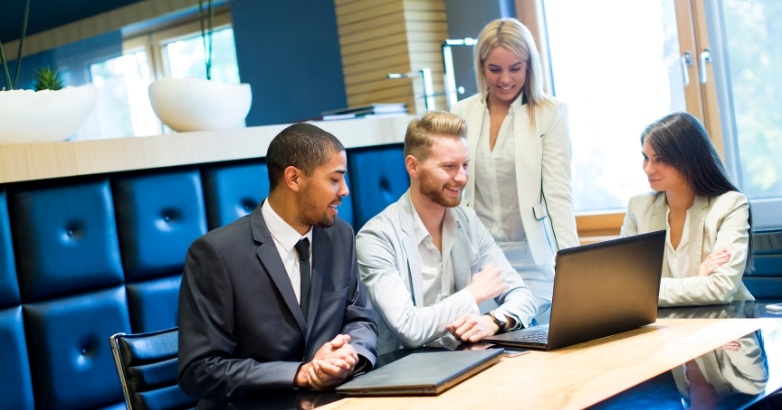 Business team engaged in a meeting about how agencies can enhance hotel digital marketing efforts.