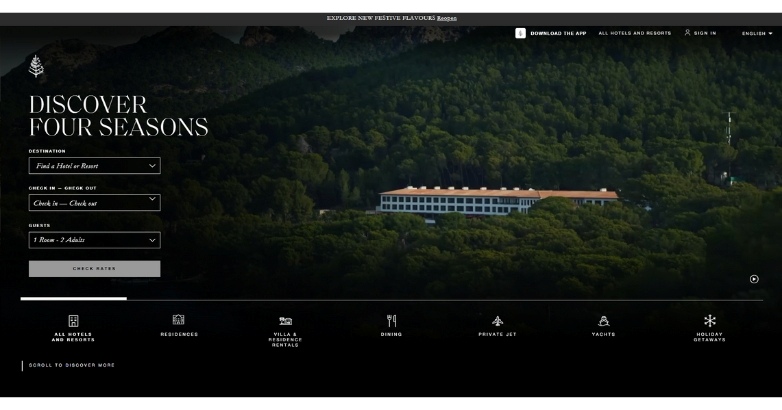 A computer monitor features the Four Seasons hotel website, emphasizing luxury accommodations and services available.
