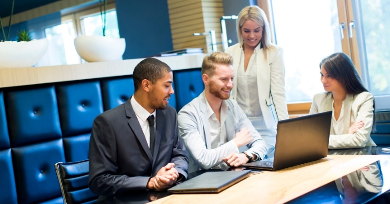 Business professionals collaborating in an office setting, focusing on hotel marketing KPIs and digital agency strategies.